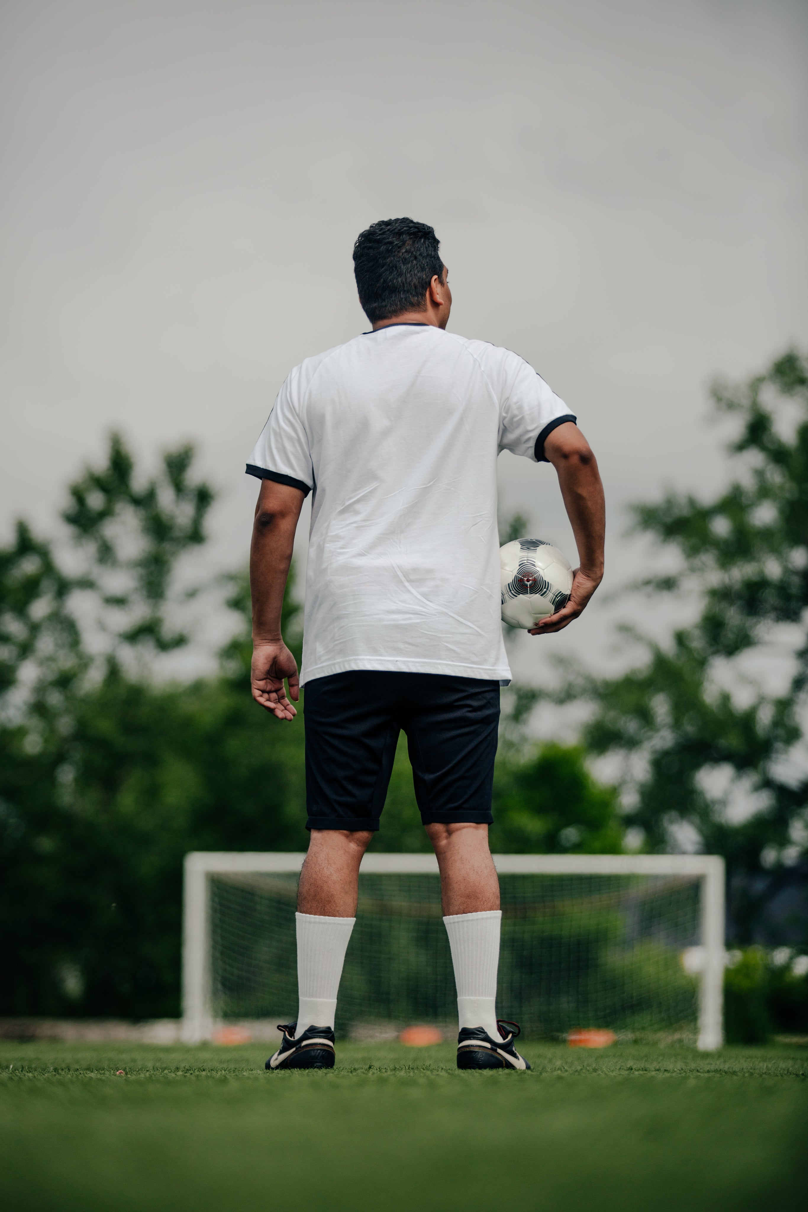 files/portrait-of-soccer-player-holding-ball-on-empty-field.jpg